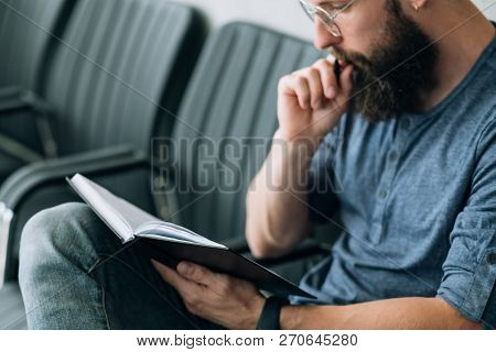 Brainwork Contemplation Thinking. Focused Man Reading Data From His Notepad.