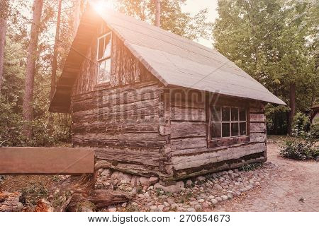 Abandoned Old Wooden House Cabin In The Woods.  View Of Old Weathered Wooden
