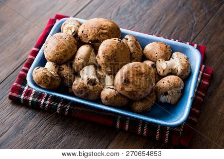 Portobello Raw Cremini Mushrooms In Plastic Container Package Or Box.