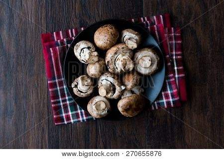 Portobello Raw Cremini Mushrooms In Black Plate.