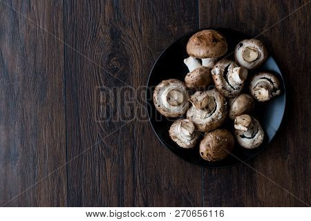 Portobello Raw Cremini Mushrooms In Black Plate.