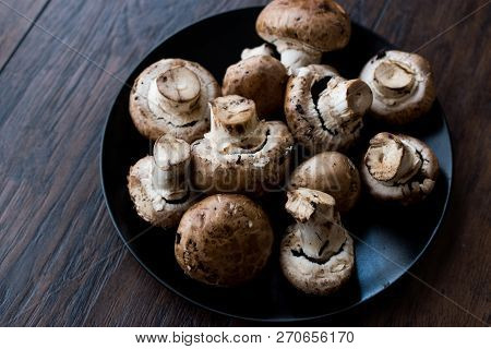 Portobello Raw Cremini Mushrooms In Black Plate.