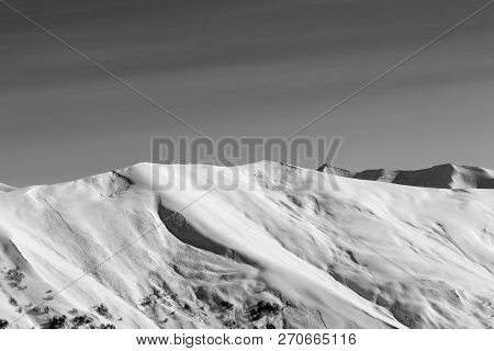 Black And White View On Off-piste Snowy Sunlight Slope With Traces From Avalanches At Sun Evening. C