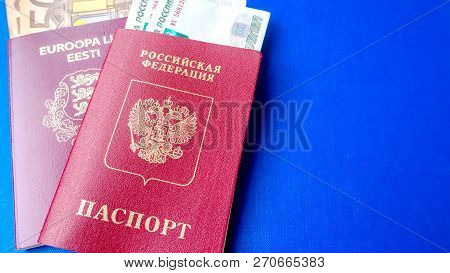 Passports On The Blue Background. Citizenship Of Estonia And Russia. Citizenship Of European Union (