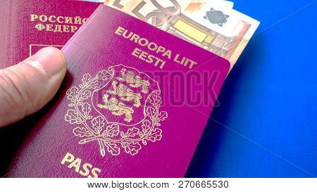 Passports On The Blue Background. Citizenship Of Estonia And Russia. Citizenship Of European Union (