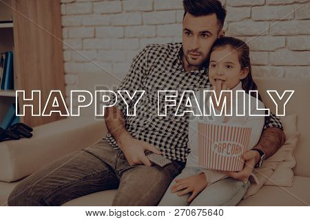Father And Daughter Are Watching Movie On Couch. Happy Family Relationship Concept. Holiday Leisure.
