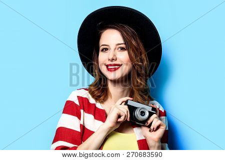 Portrait Of Young Smiling Red-haired White European Woman In Hat And Red Striped Shirt With Vintage 