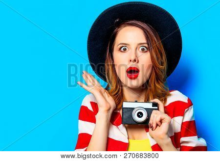 Portrait Of Young Surprised Red-haired White European Woman In Hat And Red Striped Shirt With Vintag