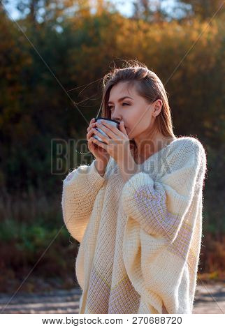 Beautiful Admiring Woman Drinking Hot Tea From Thermos Cup With Backligth Sun.