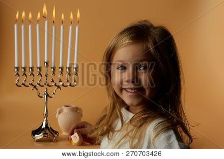Joyful Girl On Menorah Background, Candles Candles On Menorah, Isolated On Yellow, Hannuka Holiday C