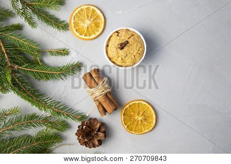 Christmas Tree Pine Brancheswith Present, Orange, Cake, Cinnamon On Grey Background. Toned