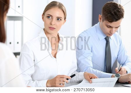 Group Of Business People Or Lawyers Discussing  Terms Of Transaction In Office. Colleagues Working A