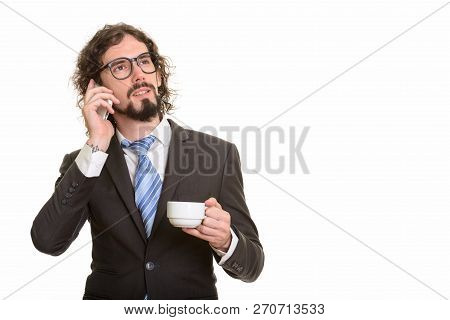 Handsome Caucasian Businessman Talking On Mobile Phone And Holdi