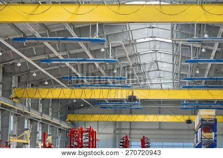 A Modern Industrial Workshop, Three Overhead Cranes Under The Ceiling.