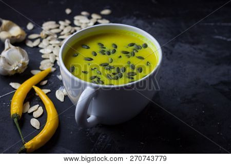 Pumpkin Asian Coconat Cream Soup. Autumn Hot Food. Chili Pepper, Garlic, Red Onion, Big Pumpkin. Dar