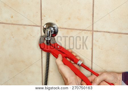 A Plumber Is Mounting A Waterskin In Bathroom