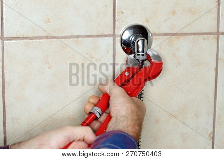 A Worker Is Mounting A Waterskin In Bathroom