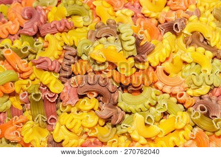 Background Of The Raw Colored Short Curly Ruffled Pasta Known As Creste Di Galli Pasta Close-up
