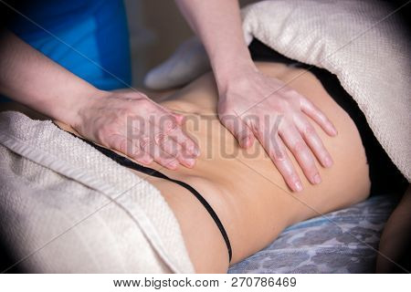 Massage Session. Young Woman Lays On The Couch While Getting Anticellulite Massage. Belly Massage