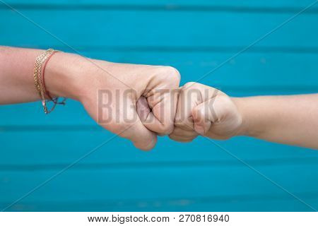Power Five, Fist Bump Or Brofist. Close-up Of Child And Mother Fists Touching Each Other