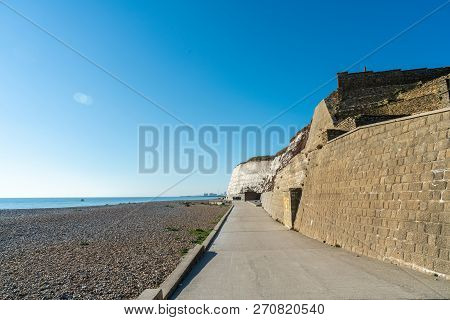 Saltdean Beach Seafront And White Sandstone Chalk Cliffs With Walkway For People Exercise. Underclif