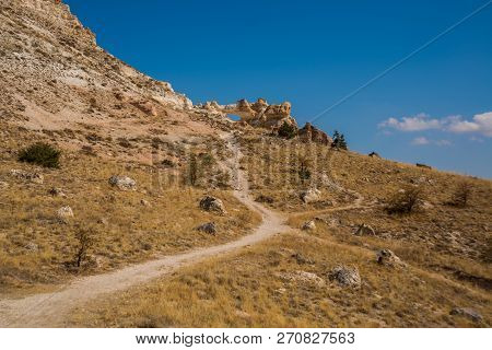 Unusual Rock On A Hill With A Hole. Beautiful Landscape In Sunny Autumn Weather. Cappadocia, Turkey