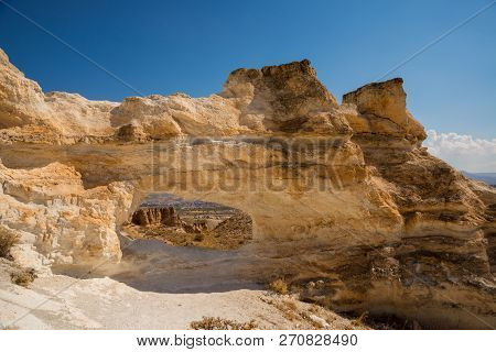 Unusual Rock On A Hill With A Hole. Beautiful Landscape In Sunny Autumn Weather. Cappadocia, Turkey