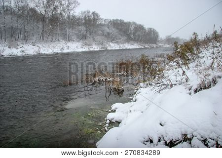 River Landscape In Winter. River With Snow-covered Coasts. River Memele In Snowfall Time. Winter In 