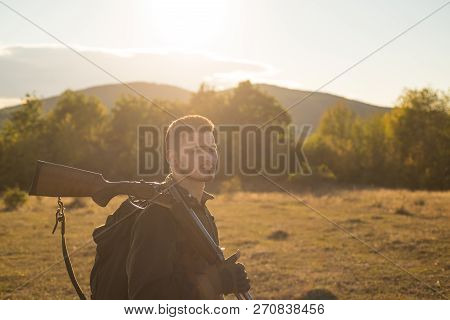 Hunter With Shotgun Gun On Hunt. Hunting Equipment For Sale. Mountain Hunting