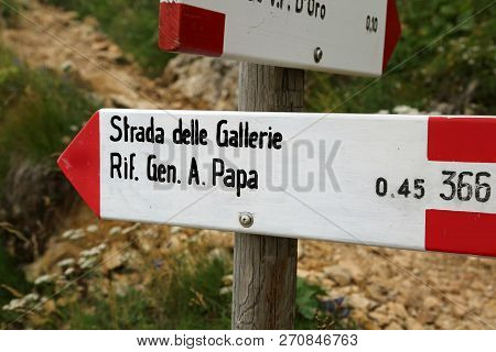 Trail Marker With Text Of Italian Location In Mountains. Strada Delle Gallerie Means Roads Of Tunnel