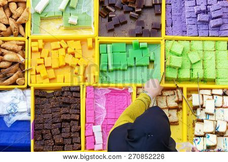 High Angle View Of Unidentified Woman Selling Traditional Asian Confectionery, Cakes And Sweet In Ko