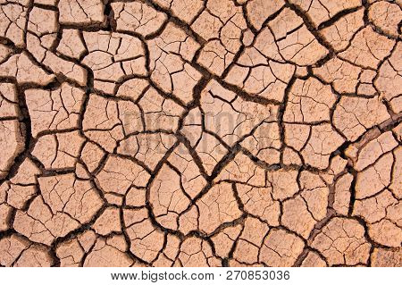 Cracked Earth, Cracked Soil. Texture Of Grungy Dry Cracking Parched Earth. Global Worming Effect.