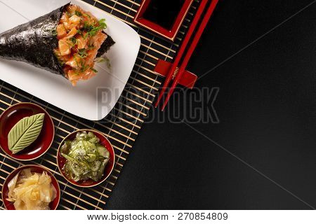 Salmon Temaki Sushi On White Plate In Black Background.