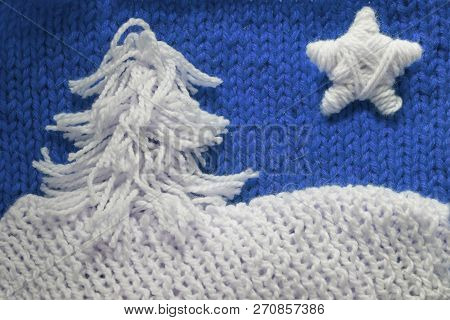 Hadmade Christmas Tree And Star On Blue Knitted Woolen Background With Copy Space For Text Christmas