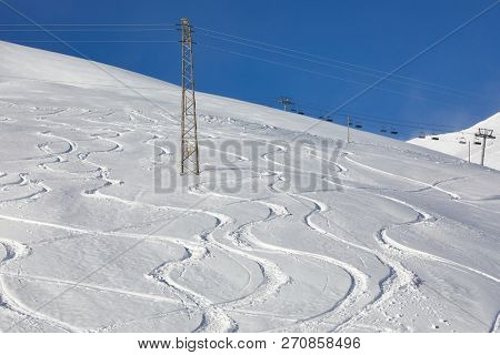 Skiers' and snowboarder's curves in the snow