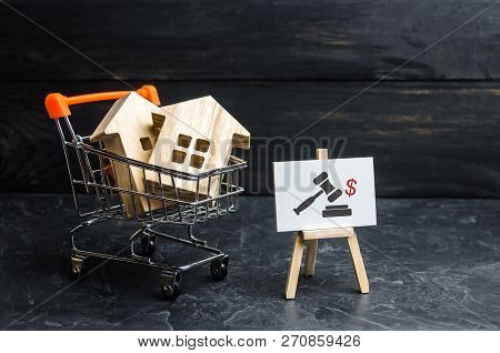 Wooden Houses In A Supermarket Cart. Uction For The Purchase Of Housing And Buildings. The Growth Of