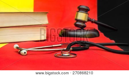 Stethoscope With Book And Gavel On German Flag. Medical Law Concept.