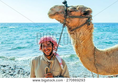 Egyptian With His Camel Posing Against The Sea, June 7, 2008, Taba, Egypt