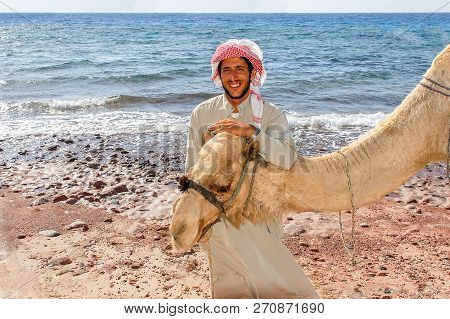 Egyptian With His Camel Posing Against The Sea, June 7, 2008, Taba, Egypt