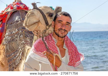 Egyptian With His Camel Posing Against The Sea, June 8, 2008, Taba, Egypt