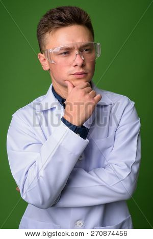 Young Handsome Man Doctor Wearing Protective Glasses Against Gre