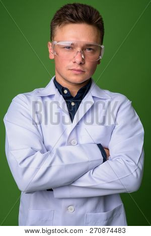 Young Handsome Man Doctor Wearing Protective Glasses Against Gre
