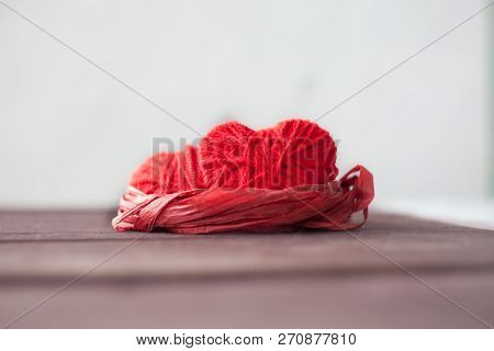 Two Red Hearts From Threads Lie In The Nest. Sweet Romantic Background. Valentines Day Concept. Sele