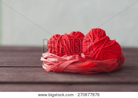 Two Red Hearts From Threads Lie In The Nest. Sweet Romantic Background. Valentines Day Concept. Sele