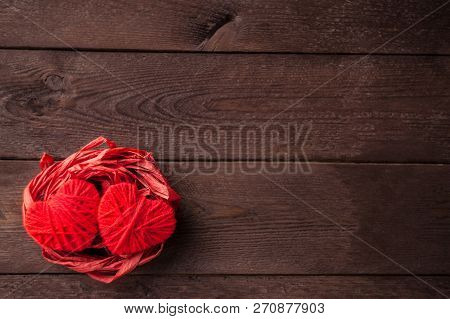 Two Red Hearts From Threads Lie In The Nest. Sweet Romantic Background. Valentines Day Concept. Sele