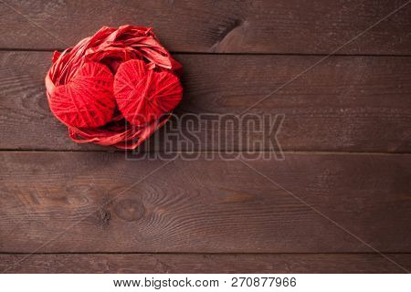 Two Red Hearts From Threads Lie In The Nest. Sweet Romantic Background. Valentines Day Concept. Sele