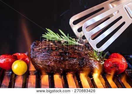 Fresh Fillet Steak On Grill With Flammes.