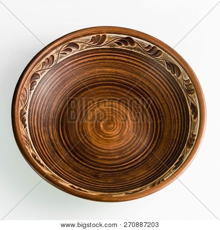 Pots And Plates Of Clay On A White Table And A Blue Background. Clay Pottery Kitchen Utensils Made B