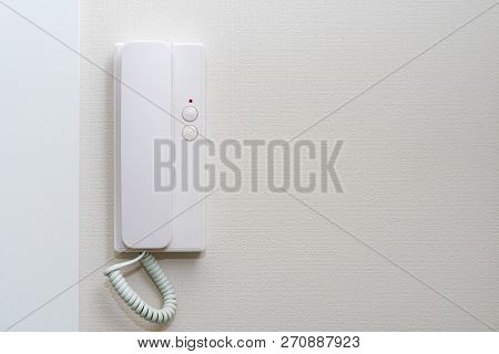 Intercom Hung On A White Wall At The Door Of Home.