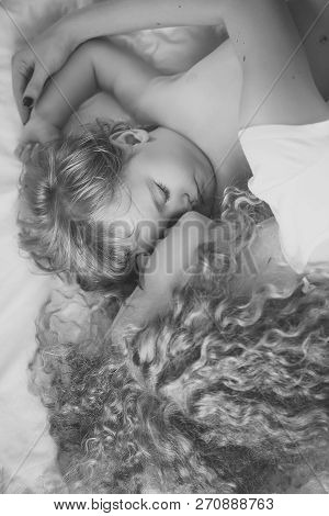Closeup Of Young Beautiful Loving Mother With Light Blonde Curly Hair Embracing Small Tiny Cute Male